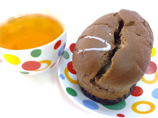 tea and chocolate bread on red tablecloth