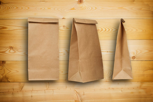 Wooden background with paper bags