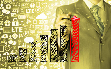 Business man drawing a growing graph