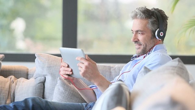 Mature man watching movie on tablet