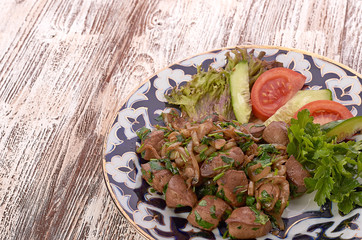 Fried meat with onion in a frying pan