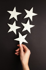 Hands holding little stars