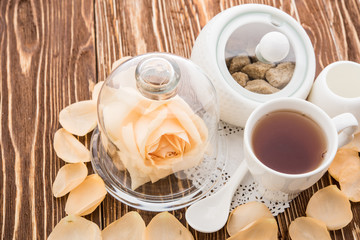 Tea cups with teapot on old wooden table