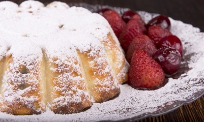 cheesecake with fruits on wooden background