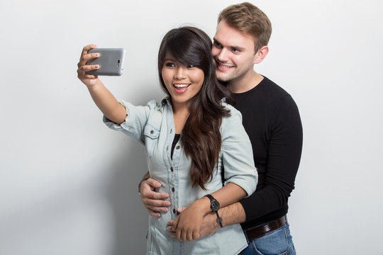  Happy Young Multiculture Couple taking self camera together