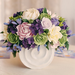 Rose flower bouquet and gift box on wooden table