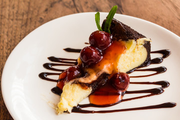 Chocolate brownie cheesecake with cherry fruit.