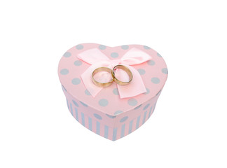 Wedding rings placed on a heart-shaped box