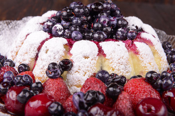 cheesecake with fruits on wooden background