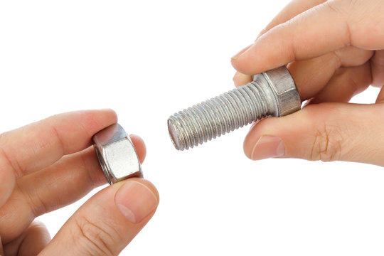 Bolt and nut in hands
