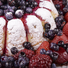 cheesecake with fruits on wooden background