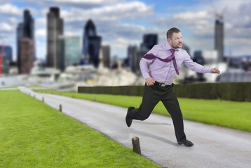 Running businessman in a hurry with modern city in background