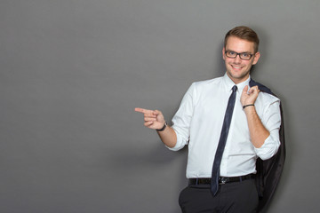 A handsome young businessman wearing glasses and smiling. Vertic