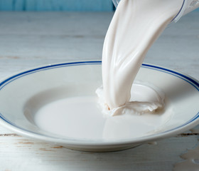 Close up of milk being poured into a plate