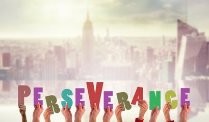 Composite image of hands showing perseverance