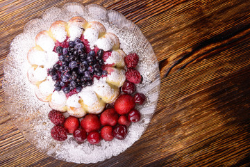 cheesecake with fruits on wooden background