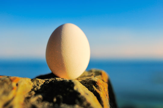 Egg in balance on stone