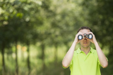 Enviromental scientist researching the environment with a binocu