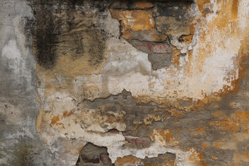 Old brick wall with cracked plaster. Background texture.