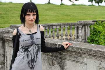 Goth girl on the top of ancient Wall