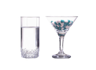 Glass with water and pills isolated on white