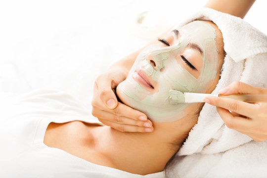 Young Beautiful Woman With Clay Facial Mask