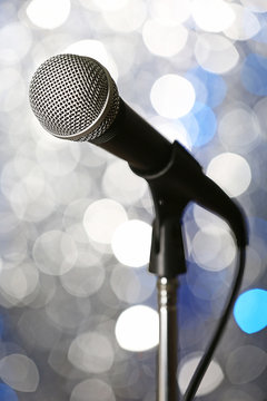 Microphone on stand on silver background