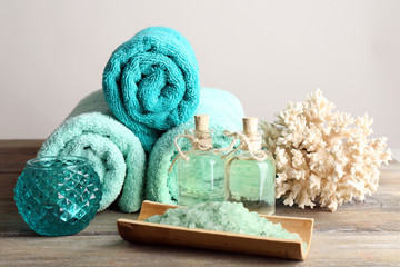 Spa composition with towels and sea salt on light background