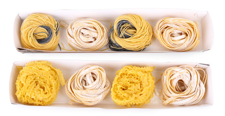 Packaged pasta tagliatelle nests isolated on white