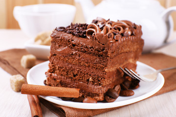 Tasty piece of chocolate cake with mint and cinnamon