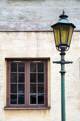 Fototapeta na wymiar Old lamp at an old facade