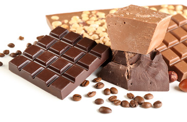 Chocolate bars with hazelnuts and coffee beans close up