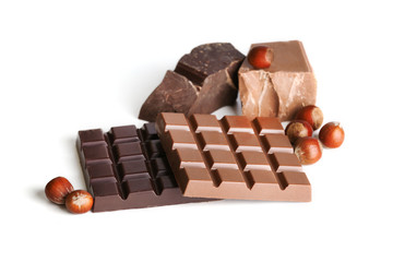 Milk and black chocolate bars with hazelnuts isolated on white