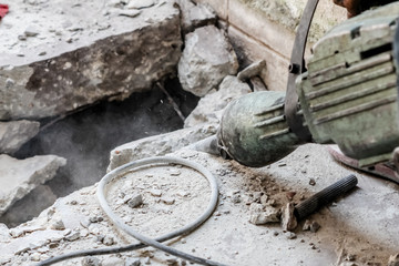 Builder worker with pneumatic hammer drill