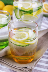 Fresh water with lemon and cucumber in glassware