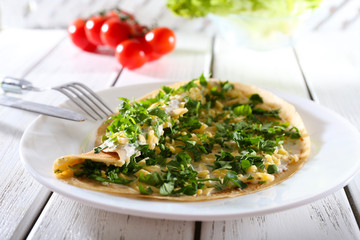 Pancakes with cream, cheese and greens in plate
