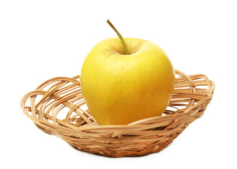Apple in wicker basket isolated on white