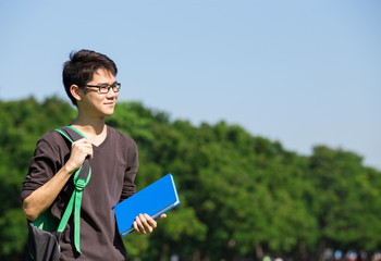 asian student in park with book and lecture in Bangkok Thailand