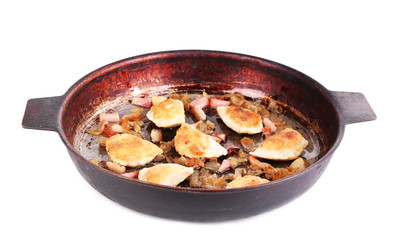 Fried dumplings with onion and bacon in frying pan, isolated