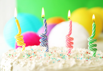 Birthday cake with candles on colorful background