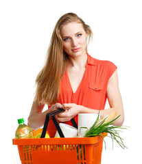 Obraz na płótnie Canvas Happy woman holding a basket full of healthy food. Shopping