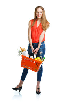 Happy woman holding a basket full of healthy food. Shopping