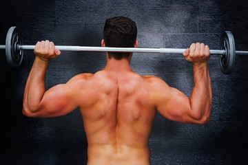 Fototapeta na wymiar Composite image of bodybuilder lifting barbell