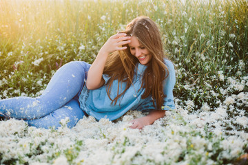 Girl with feathers at sunset