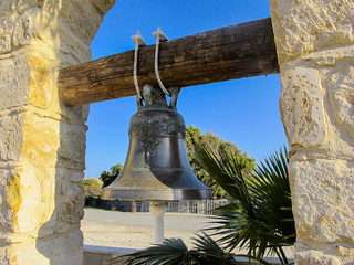 Obraz premium brass bell in the courtyard of the church, cyprus