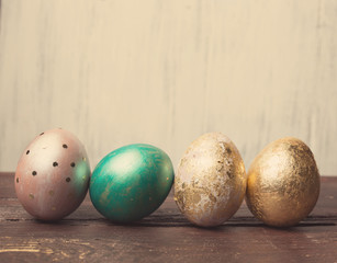 Easter eggs on rustic wooden table. Holiday background. Tinted p