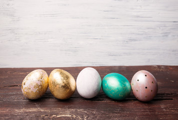 Easter eggs on rustic wooden table. Holiday background. Tinted p