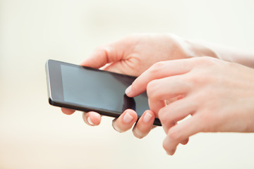Close up of a woman using mobile smart phone