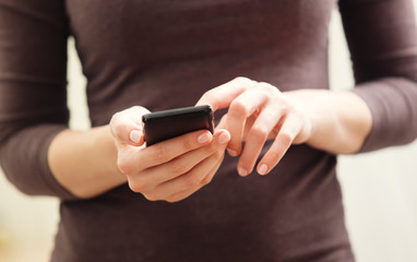 Close up of a woman using mobile smart phone