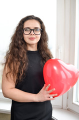 Attractive caucasian woman holding a baloon heart